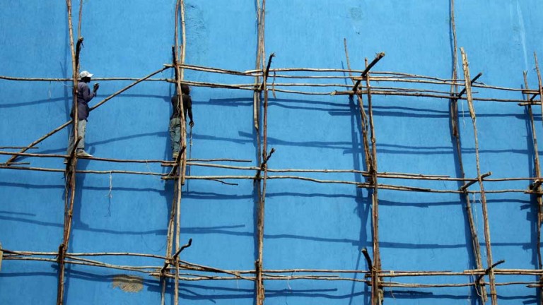 Man on wooden scaffolding