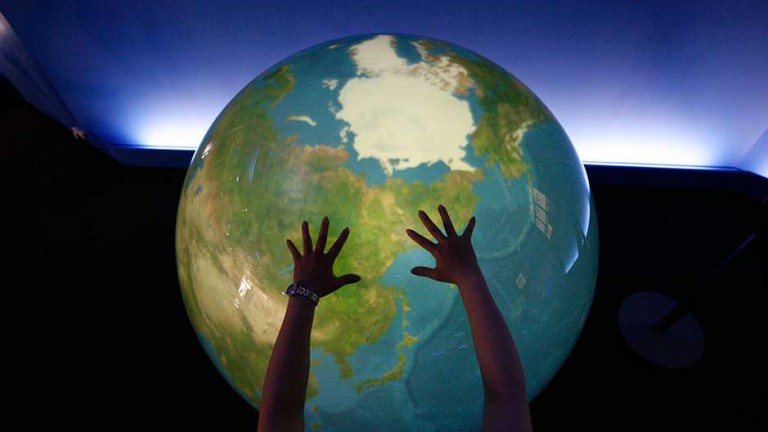 A visitor places her hands on a 