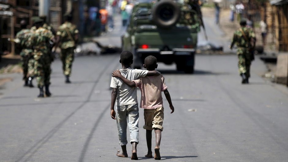 Boys behind patrolling soldiers, Burundi